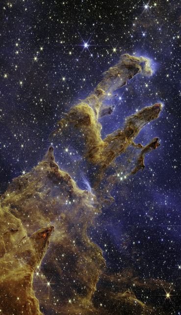 Columns of gas and dust in the Eagle Nebula where new stars are forming, seen in the infrared.